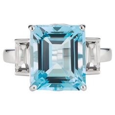 Inspired by the sparkling hues of the Mediterranean Sea, this elegant ring from the Andalusian Collection features a stunning natural sky blue topaz surrounded by two dazzling white topaz baguettes, set in 9ct white gold. The Andalusian-inspired luxury jewellery London designed collection takes inspiration from Hispano-Moorish architectural styles of the enchanting southernmost region of Spain. The gemstone jewellery from this collection designed by British Jewellers boasts vibrant yet sophisticated combinations of natural-coloured gemstones with precious metals. Our luxury gemstone jewellery piece, the Octagon White Gold Ring in White Topaz & Blue Topaz octagon-cut central stone measures 12x10mm and side stones baguettes measure 6x3mm. The gemstones are set in a luxurious Solid 9ct White Custom Gold Jewelry, Topaz Birthstone, Architectural Styles, Emerald Cut Rings, Luxury Jewellery, Sky Blue Topaz, Peridot Gemstone, Gemstone Jewellery, Topaz Stone