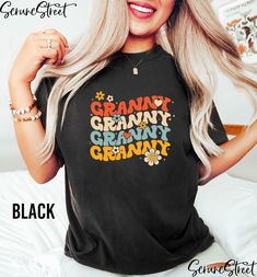 a woman with long blonde hair wearing a black granny granny t - shirt