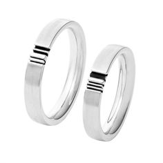 two silver rings with black stripes on them