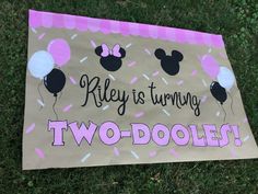 a sign that says, riley is turning two - doodles with balloons on it