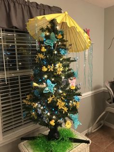 a decorated christmas tree with an umbrella on top