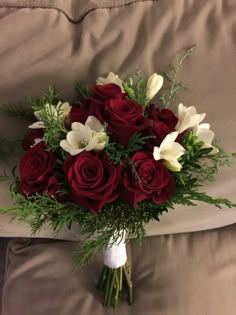 a bouquet of red roses and white flowers