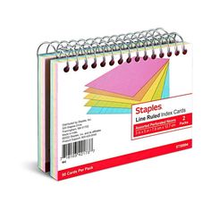 a spiral bound note book with colored paper