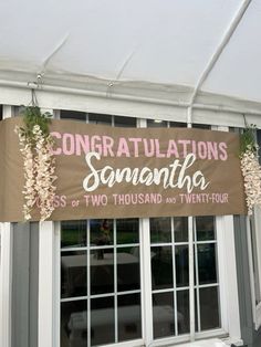 a sign hanging from the side of a building that says congratulations sonantha, two thousand and twenty - four