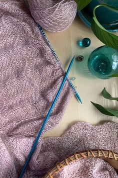 yarn, knitting needles and glassware on a table