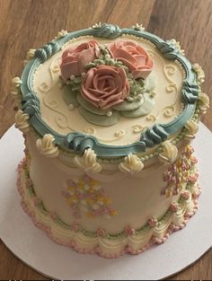 there is a cake that has been decorated with flowers on the top and bottom layer