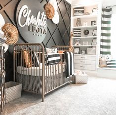 a baby's room decorated in black and white with the name charlotte lota on the wall