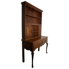 an old fashioned wooden desk with drawers on the top and bottom, against a white background