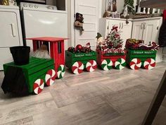 christmas decorations in green and red boxes on the floor