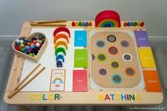 a child's play table with lots of colorful materials and wooden utensils