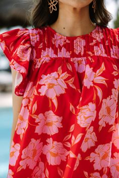 We are all caught up with this blouse! That floral print is so tropical and perfect for the summer! We really love that fit as well! Round neckline Button keyhole back Ruffled cap sleeves Floral print No stretch Savannah is wearing the small. Spring Tropical Red Top, Tropical Red Top For Spring, Tropical Short Sleeve Floral Print Blouse, Red Flutter Sleeve Blouse For Summer, Vacation Blouse With Floral Print And Flutter Sleeves, Spring Floral Print Hawaiian Blouse, Spring Hawaiian Blouse With Floral Print, Red Hawaiian Tops For Spring, Fitted Hawaiian Floral Print Tops