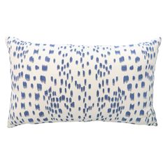 a white and blue pillow with black spots on the front, sitting on a white background