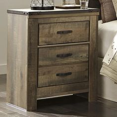 a night stand with two drawers and a lamp