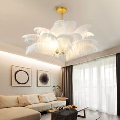 a living room filled with furniture and a chandelier hanging over the top of it