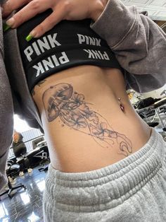 a woman with a tattoo on her stomach