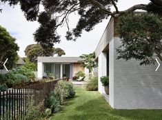 the house is surrounded by lush green grass