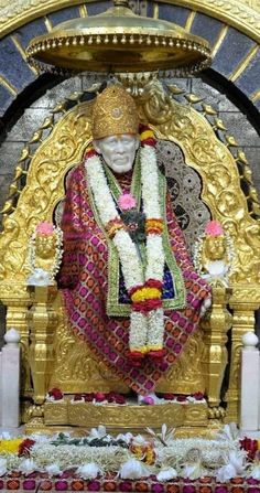 the statue is decorated with flowers and garlands