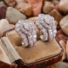 These captivating "J" style earrings are each centered with a pear brilliant cut diamond in a five-prong setting. The earrings are accented with fourteen (14) round single cut diamonds and thirteen (13) round brilliant cut diamonds in bead settings. The earrings measure 22.0mm long by 16.1mm wide and 19.3mm deep, finished with posts and omega backs. Classic Diamond Clip-on Earrings With Brilliant Cut, Formal Teardrop Single Cut Diamond Earrings, Luxury Pear-shaped Single Cut Diamond Earrings, Elegant Pear-shaped Earrings With Single Cut Diamonds, Elegant Pear-shaped Single Cut Diamond Earrings, Luxury Formal Cluster Earrings With Single Cut Diamonds, Formal Pear-shaped Diamond Earrings With Single Cut Diamonds, Luxury Platinum Cluster Earrings In Diamond White, Luxury Diamond White Platinum Cluster Earrings