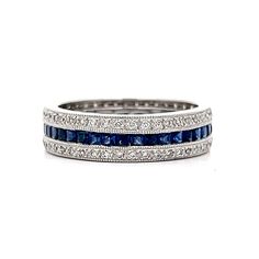 a white gold ring with blue sapphires and diamonds on the sides, set in 18k white gold