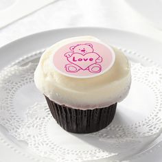 a cupcake on a plate with a sticker that says love in the middle