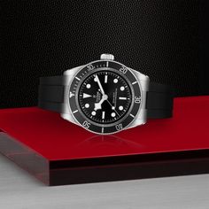 A Tudor "Black Bay" model wristwatch. The watch features a 41mm stainless steel case, a 60-minute unidirectional bezel in stainless steel with a red aluminum insert, a 70-hour power reserve, water proof to 200 meters, a black domed dial, a Manufacture Calibre MT5602-U self-winding mechanical movement with bidirectinoal rotor system, and a domed sapphire crystal. Five-year Guarantee: Five-year transferable guarantee with no registration or periodic maintenance checks required Case: 41mm stainless steel case with polished and satin finish Bezel: 60-minute unidirectional bezel in stainless steel with aluminum insert Movement: Manufacture Calibre MT5602-U. Self-winding mechanical movement with bidirectional rotor system. 70-hour power reserve Dial: black, domed Winding Crown: Stainless steel s Monochromatic Aesthetic, Rolex Tudor, Tudor Black Bay, Rubber Bracelets, The Tudor, Custom Ring Designs, Fire Heart, Mechanical Movement, Custom Jewelry Design