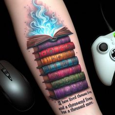 a tattoo with books on it and a game controller next to it