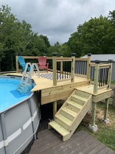 an above ground pool with steps leading up to it and a deck next to the pool