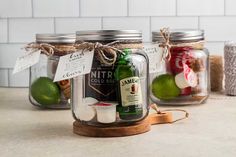 three mason jars filled with different types of food and drinks on top of a counter