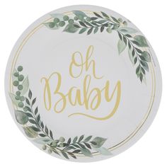 a white plate with the words oh baby painted on it and green leaves around it