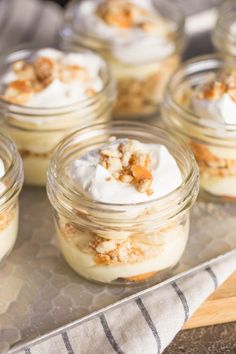 small desserts in glass jars sitting on a tray