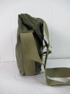 "Unique vintage 1940s WWII era green cotton canvas shoulder bag. Has unique tie down closures. Maybe a hunting bag or military bag. No manufacturer's label. Bag measures 12\" tall, 8\" wide and 4.5\" thick. In very good condition with name written in marker on the strap." Vintage Green School Bag, Green Vintage School Bag, Green Satchel Shoulder Bag With Canvas Lining, Vintage Khaki Shoulder Bag For Everyday, Green Vintage Satchel For Everyday Use, Vintage Green Everyday Satchel, Everyday Vintage Khaki Shoulder Bag, Everyday Vintage Green Satchel, Vintage Waxed Canvas Bag For Daily Use