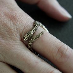 This beautiful garter snake ring is made of silicon bronze with a burnished oxidized finish to enhance the finely carved details. He is 3/4" at the widest point but does not impede finger movement because all the curves are in the right places. This little fellow is available from a size 4 to 13.ALTERNATIVE STYLES:I make a variety of different rings in a number of finishes to suit all styles, tastes and pocketbooks, check them out here:  http://www.etsy.com/shop/mrd74?section_id=7205630MOON RAVE Bronze Open Ring Jewelry For Anniversary, Symbolic Bronze Brass Jewelry, Bronze Jewelry With Antique Finish For Anniversary, Engraved Brass Open Ring Jewelry, Antique Gold Hand Cast Jewelry, Antique Bronze Jewelry For Anniversary, Antique Hand Cast Gold Jewelry, Antique Finish Bronze Jewelry For Anniversary, Bronze Antique Finish Jewelry For Anniversary