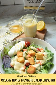 A green salad is drizzled with this golden, creamy honey mustard salad dressing. A mason jar with the dressing, a spoon and a small bowl of honey is slightly blurred in the background. Creamy Honey Mustard Dressing, Salad Dressing Recipes Honey Mustard, Spicy Mustard Salad Dressing, Simple Honey Mustard Dressing, Homey Mustard Salad Dressing, Mustard Salad Dressing, Honey Mustard Salad Dressing, Honey Mustard Sauce, Refreshing Salad