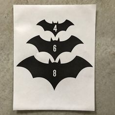 four bats with numbers in the middle on a piece of paper that has been cut out