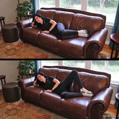 a woman laying on top of a brown couch