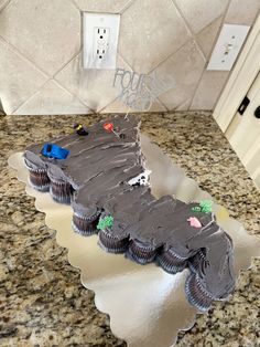 a cake shaped like a car on top of a counter next to a light switch