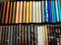 many different colors of wrapping paper on a shelf