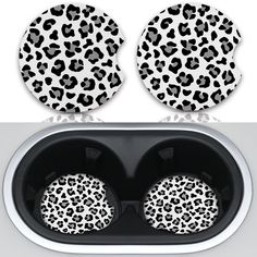 two plates with black and white animal print on them, next to a stove top oven