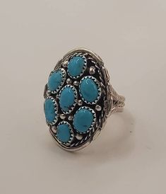 "Stunning multi stone Turquoise ring.  This beautiful concho ring is handmade using sterling silver and genuine turquoise stones. This ring measures 1 1/4\" long and 1\" wide, which definitely makes it a statement piece! This piece is stamped sterling and stamped with the maker's mark. This gorgeous large ring would make a wonderful gift for mom, gift for girlfriend, gift for cowgirl, anniversary gift or a wonderful self care gift for you!   I also have matching bracelets, necklace and earrings that make the perfect compliment to this gorgeous cluster ring.  Check out my other listings to complete your look!" Southwestern Concho Rings As Gifts, Southwestern Style Concho Rings As Gifts, Western Style Concho Rings As A Gift, Nickel Free Round Southwestern Turquoise Ring, Southwestern Concho Ring As A Gift, Western Style Concho Rings For Gift, Unique Turquoise Ring With Concho For Gift, Western Style Oval Turquoise Ring With Concho, Southwestern Style Turquoise Ring Stamped 925