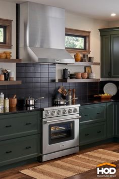 a stove top oven sitting inside of a kitchen next to green cabinets and counter tops