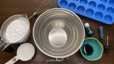 an assortment of kitchen supplies including measuring spoons and bowls