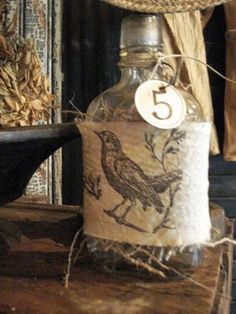 a bottle with a bird on it sitting on a table