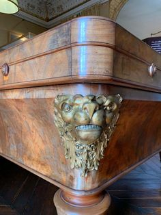 a wooden table with a lion head on it