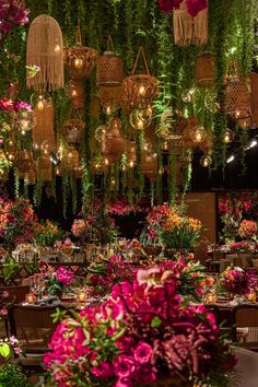 a room filled with lots of flowers and hanging lights