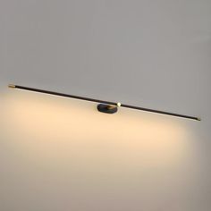 a light that is on the side of a wall with a dimmer in front of it