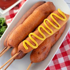 a hot dog on a plate with ketchup and mustard