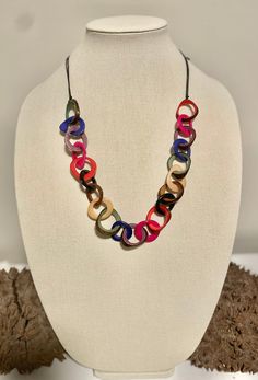 Handmade in Ecuador Necklace Length: 13 - 32 Inches Adjustable Length Material: Tagua Nut Due to this item being handmade and the nature of the Tagua Nut the size and the color may vary from piece to piece Everyday Artisan Multicolor Jewelry, Multicolor Round Necklaces For Everyday, Handmade Multicolor Circular Jewelry, Multicolor Circle Necklace For Gift, Everyday Multicolor Necklaces With Adjustable Chain, Multicolor Circle Necklace Gift, Everyday Multicolor Necklace With Adjustable Chain, Everyday Multicolor Handmade Jewelry, Multicolor Adjustable Chain Beach Jewelry