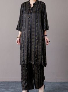 Elevate your wardrobe with our Elegant Black and Gold Embroidered Long Shirt and Wide-Leg Pants Set. This sophisticated ensemble features a long shirt adorned with intricate gold embroidery, offering a touch of luxury and elegance. The matching wide-leg pants provide a comfortable yet stylish fit, perfect for both formal and casual occasions. Made from high-quality fabric, this set ensures you look effortlessly chic and poised. Pair with your favorite accessories to complete the look. Key Features: Black long shirt with luxurious gold embroidery Matching wide-leg pants for a comfortable fit High-quality fabric for a chic appearance Perfect for both formal and casual events Versatile design for various styling options Traditional Long Sleeve Palazzo Set With Gold Embroidery, Festive Long Sleeve Palazzo Set With Gold Embroidery, Embroidered Long Sleeve Pant Set For Work, Traditional Embroidered Pant Set For Workwear, Elegant Black Pant Set For Festive Occasions, Black Palazzo Set With Floral Embroidery For Eid, Black Sets For Work Wear And Eid, Traditional Black Sets For Workwear, Traditional Black Pant Set For Eid