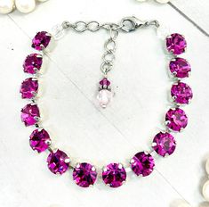 FUCHSIA PINK TENNIS BRACELET, NECKLACE, AND EARRINGS. I made this Bracelet with genuine fuchsia (pink) crystal elements. This crystal carries the most vibrant color of pink to wear everyday or to wear to any special event.   As an added touch, an antique style charm has been added to the extension chain. You can add a necklace and pair of earrings to your bracelet.  Top quality European components are used in all jewelry pieces. This means the metal is better quality and the prongs that hold the Pink Crystal Necklace, Pink Crystal Bracelet, Pink Tennis, Bridal Packages, Bracelet Tennis, Pink Cups, Fuchsia Pink, Sparkling Crystal, Faceted Crystal