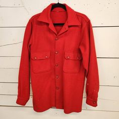 "Vintage red wool shirt jacket. Originally a Boy Scouts Jacket. Tag has been cut out. Excellent condition. Does have some slight discoloration on the back and around the cuff. Missing very top button. Fits like a large roughly 42L 22\" pit to pit  18\" shoulder to shoulder 33\" shoulder to hem 26.5\" shoulder to cuff B09" Wool Button-up Top For Winter, Vintage Solid Color Button-up Outerwear, Collared Wool Outerwear With Snap Buttons, Vintage Outerwear With Button Cuffs, Vintage Long Sleeve Outerwear With Button Cuffs, Vintage Red Long Sleeve Outerwear, Red Long Sleeve Outerwear With Button Cuffs, Vintage Red Button-up Outerwear, Red Wool Single-breasted Outerwear